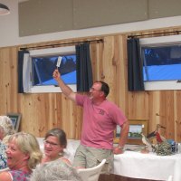 Shay Trainer bids $1400 for an Ocracoke fig cake made by Ruth Toth. Ruth's cake won the 2015 Fig Cake Bake-Off last August. Her two chocolate cakes went for $500 each at this year's Firemen's Ball!
