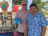 Irving Jones of Kitty Hawk, NC, a long time visitor to Ocracoke, looks through t-shirts with Eduardo.
