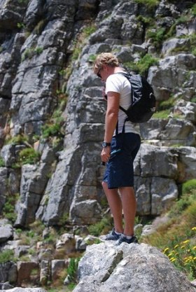 Hospitality Professionals on Vacation Brad taking a break while climbing Table Mountain, which "nearly killed" Sarah.