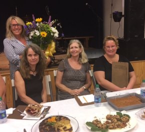 Karen shows off her flowers (part of her First Place winnings) with judges Debbie Wells, Flavia Burton, and Crystal Canterbury. Her cut cake is bottom left.