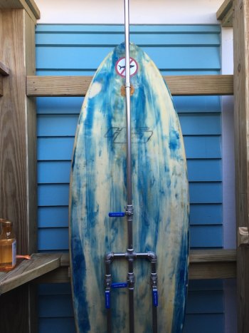 Historic Howard St. Home Renovated The outdoor shower features a repurposed surfboard.