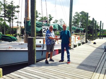 Fair Winds, Wilma Lee Buck Buchanan of Annapolis Maritime Museum and Tom Pahl of Ocracoke Alive shake on it.