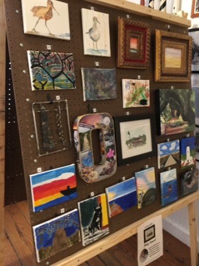 Art Auction Raises $6000 for OPS Museum staff displayed art on giant easels built by the Ocracoke school shop glass under the direction of Gary Mitchell.