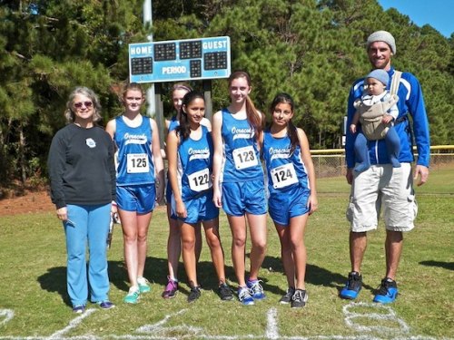 The girls with coaches Kitty Mitchell and Adam Burleson, and mascot Luca Burleson. 