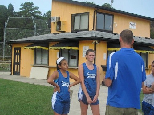 Dolphins Are Conference Champs! Last minute instructions, with Karen, Kaylee, and Coach B. Of course, Karen just runs flat out as hard as she can. I don't think you can instruct that. Karen is a freshman, other teams in the conference should be scaared.