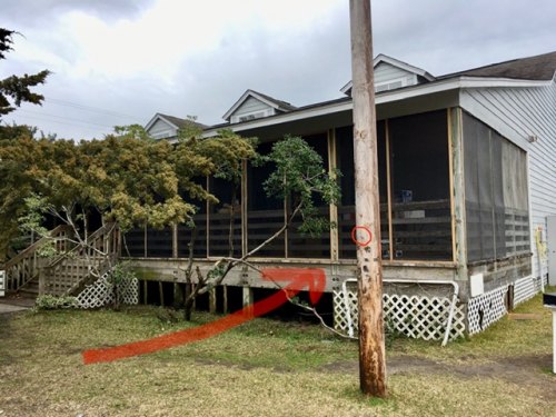 Ocracoke Library is one of the buildings that will benefit from the Golden LEAF grant to Hyde County Schools. The nail in the pole shows the height of the flood (7 feet above sea level). Once elevated, the library will be 8' above sea level.